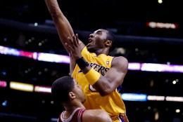 Los Angeles Lakers' Kobe Bryant, top, goes up for a layup against Houston Rockets' Maurice Taylor during the fourth quarter of a first-round Western Conference NBA playoff game Saturday, April 17, 2004, at Staples Center in Los Angeles. Bryant scored 16 points in the Lakers' 72-71 win. (AP Photo/Kevork Djansezian)