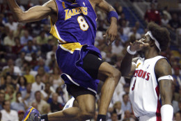 Los Angeles Lakers Kobe Bryant (8) goes by Detroit Pistons Ben Wallace (3) in the first half of  Game 5 of the NBA Finals in Auburn Hills, Mich. Tuesday night June 15, 2004. (AP Photo/ Paul Sancya )