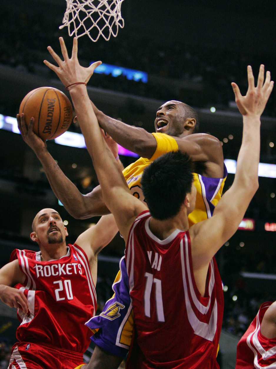 Los Angeles Lakers' Kobe Bryant puts up a shot as Houston Rockets' Yao Ming and Jon Barry guard during the second half Friday night, Jan. 7, 2004, in Los Angeles. (AP Photo/Mark J. Terrill)