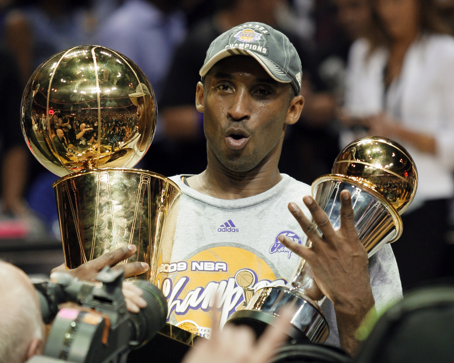 Los Angeles Lakers' Kobe Bryant holds the Larry O'Brien championship trophy and finals MVP trophy after the Lakers beat the Orlando Magic 99-86 in Game 5 of the NBA basketball finals Sunday, June 14, 2009, in Orlando, Fla. (AP Photo/David J. Phillip)
