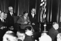 Bruno Richard Hauptmann shown examining the Lindbergh Ransom notes when called back to the witness stand in a surprise move at his extradition hearing in New York, Oct. 16, 1934. He examined the notes one by one for ten minutes, and declared: This is not my handwriting. It is the first time I have ever seen these papers. (AP Photo)