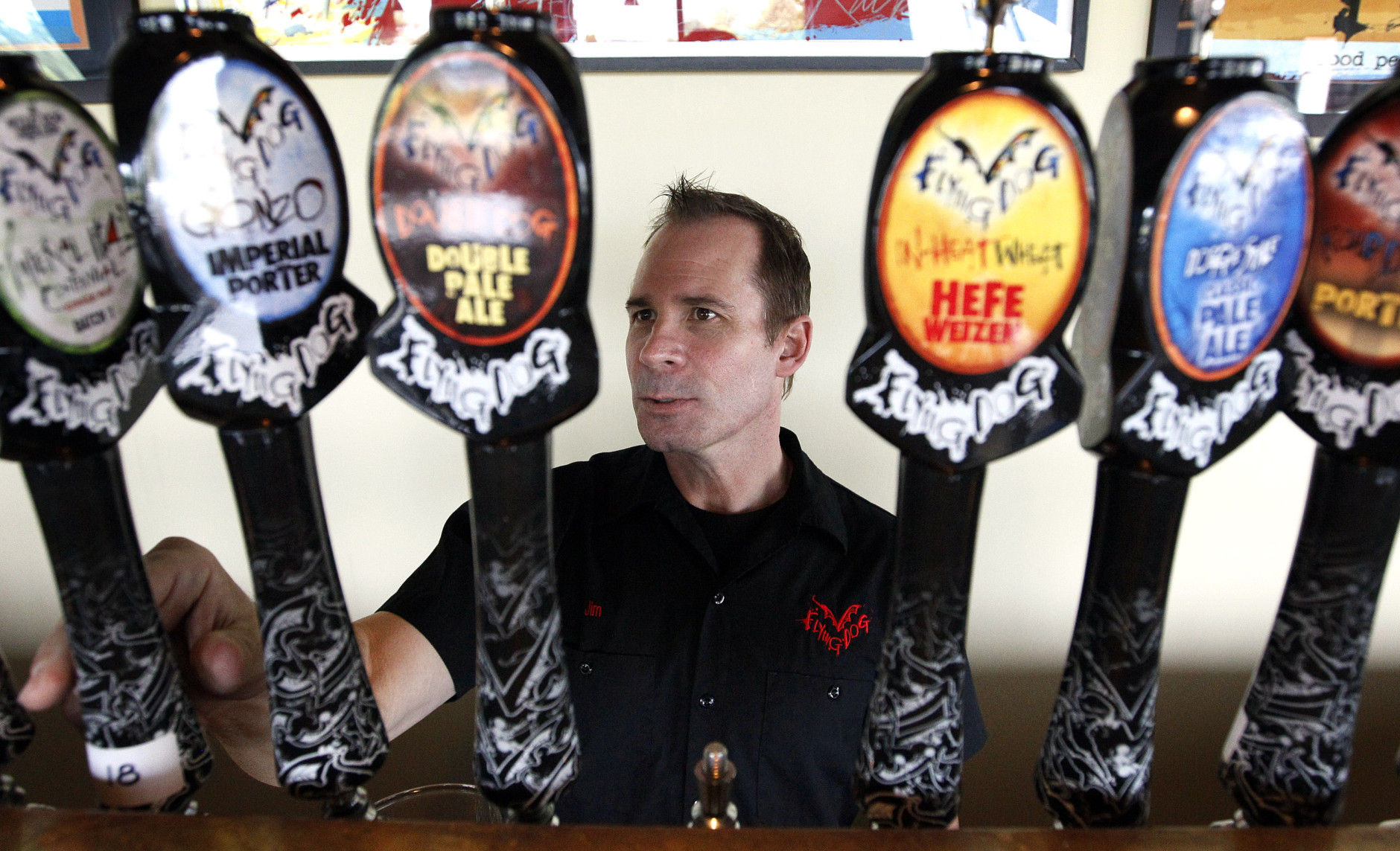 In this July 25, 2011 photo, Flying Dog Brewery CEO Jim Caruso selects a beer to pour from a tap at the brewery's headquarters in Frederick, Md. (AP Photo/Patrick Semansky)