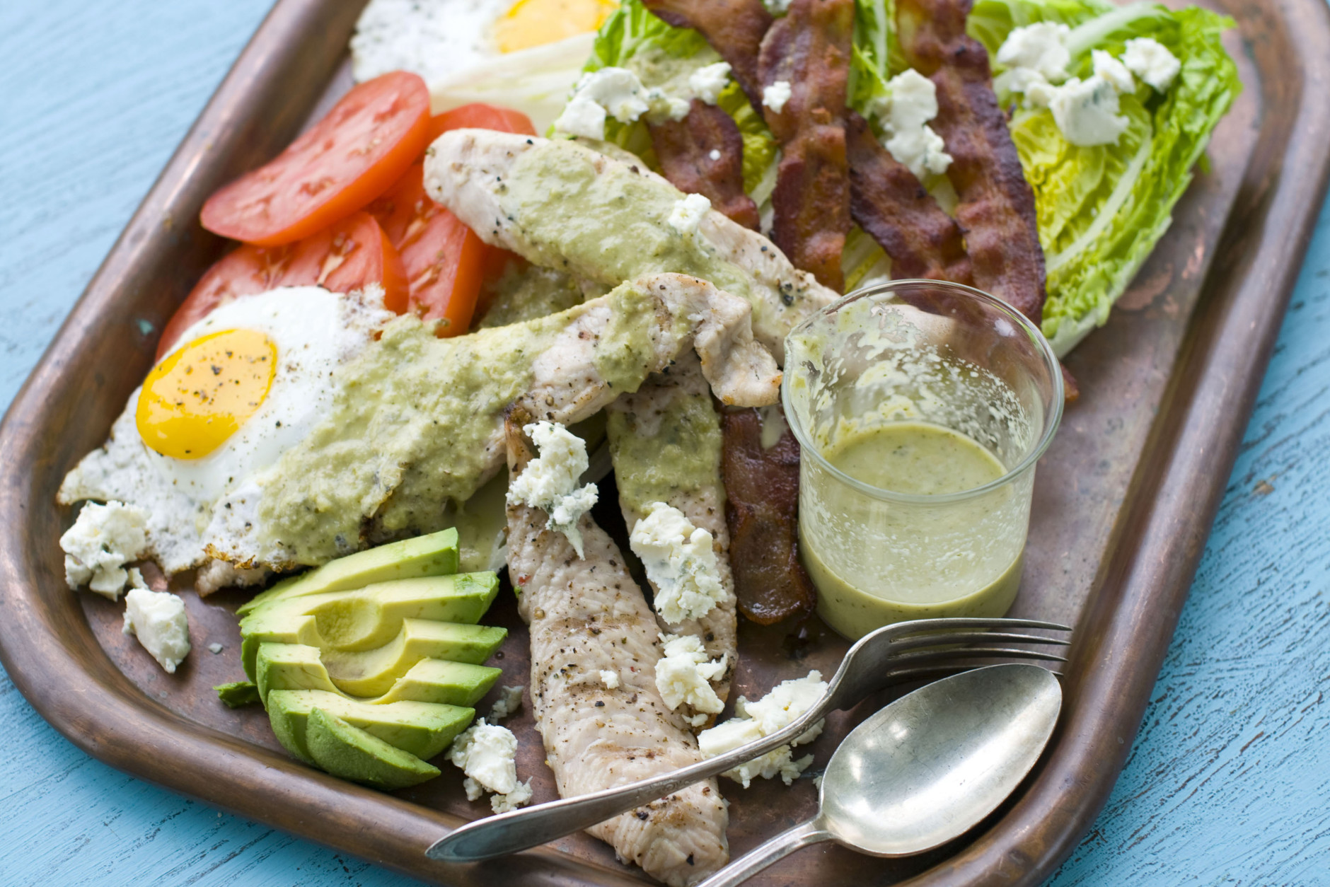 This image taken on May 30, 2012 in Concord, N.H. shows a grilled Cobb salad made with chicken, egg, avocado, tomato, bacon, blue cheese, and greens displayed on a platter. (AP Photo/Matthew Mead)