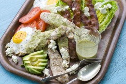 This image taken on May 30, 2012 in Concord, N.H. shows a grilled Cobb salad made with chicken, egg, avocado, tomato, bacon, blue cheese, and greens displayed on a platter. (AP Photo/Matthew Mead)