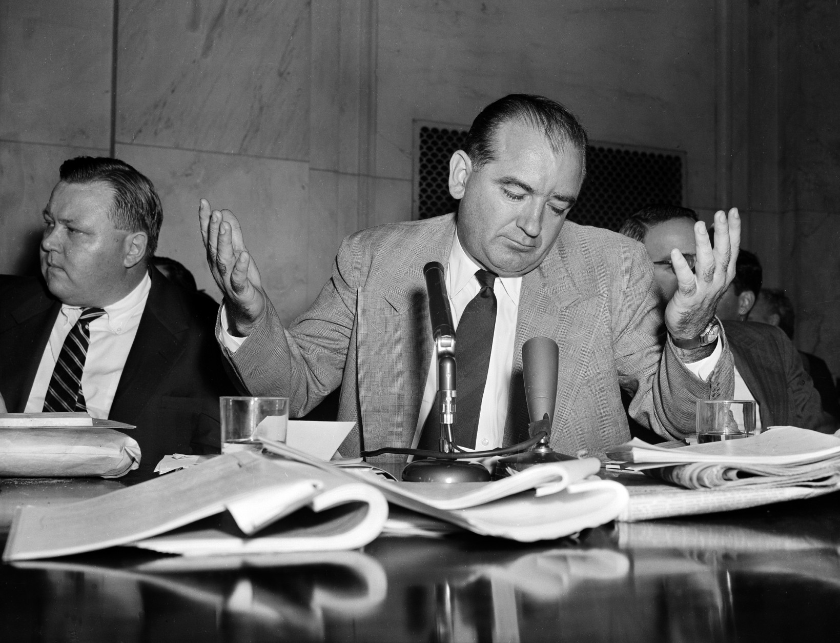 Sen. Joseph McCarthy, R-Wis., gives a resigned shrug at being unable to get across with one of his "point of order" interruptions, during the Senate Investigation Subcommittee hearing, in Washington, D.C., April 30, 1954. Pvt. G. David Schine was in the witness chair at the time. (AP Photo/WF)