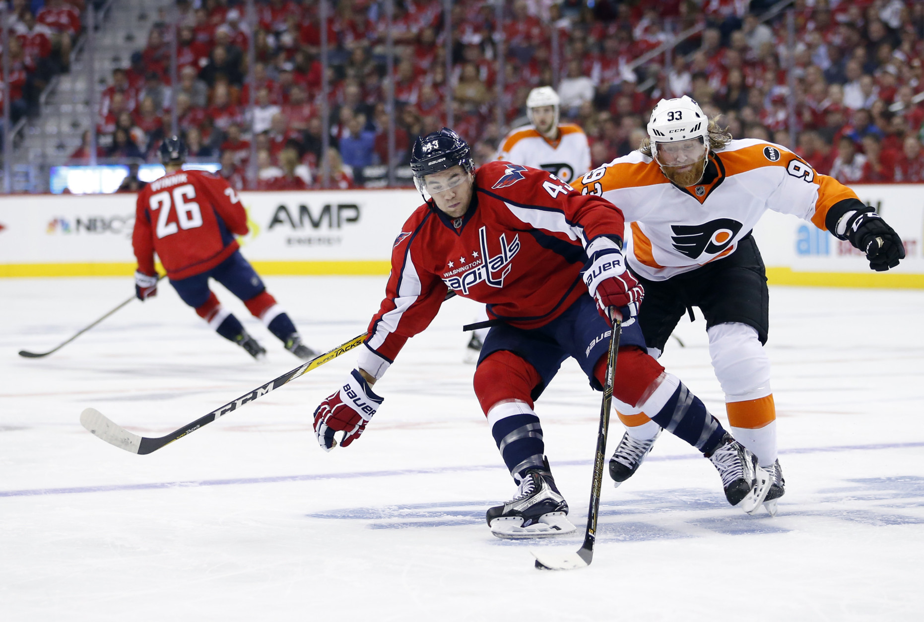 Washington Capitals right wing Tom Wilson (43) skates with the puck with Philadelphia Flyers left wing Jakub Voracek (93), from the Czech Republic, behind him during the first period of Game 1 of a first-round NHL hockey Stanley Cup playoff series Thursday, April 14, 2016, in Washington. (AP Photo/Alex Brandon)