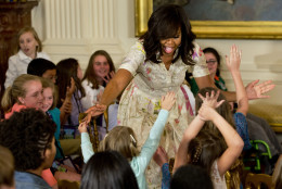 Children clamor to receive hugs from first lady Michelle Obama during the annual White House Take Our Daughters and Sons to Work Day event attended by the children of Executive Office employees, young people from Big Brothers Big Sisters of America, SchoolTalk, and the D.C. Child and Family Services Agency, in the East Room of the White House in Washington, Wednesday, April 20, 2016. (AP Photo/Jacquelyn Martin)