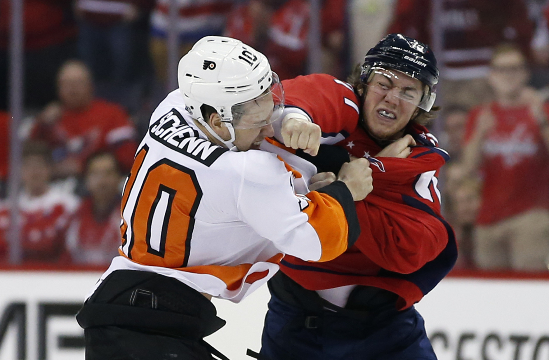 Philadelphia Flyers center Brayden Schenn (10) and Washington Capitals right wing T.J. Oshie (77) fight during the first period of Game 5 in the first round of the NHL Stanley Cup hockey playoffs Friday, April 22, 2016, in Washington. (AP Photo/Alex Brandon)