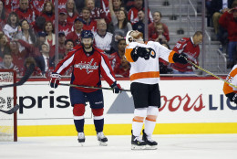 Philadelphia Flyers center Ryan White, right, celebrates his goal next to Washington Capitals defenseman Taylor Chorney, left, during the second period of Game 5 in a first-round NHL Stanley Cup hockey playoff series, Friday, April 22, 2016, in Washington. (AP Photo/Alex Brandon)