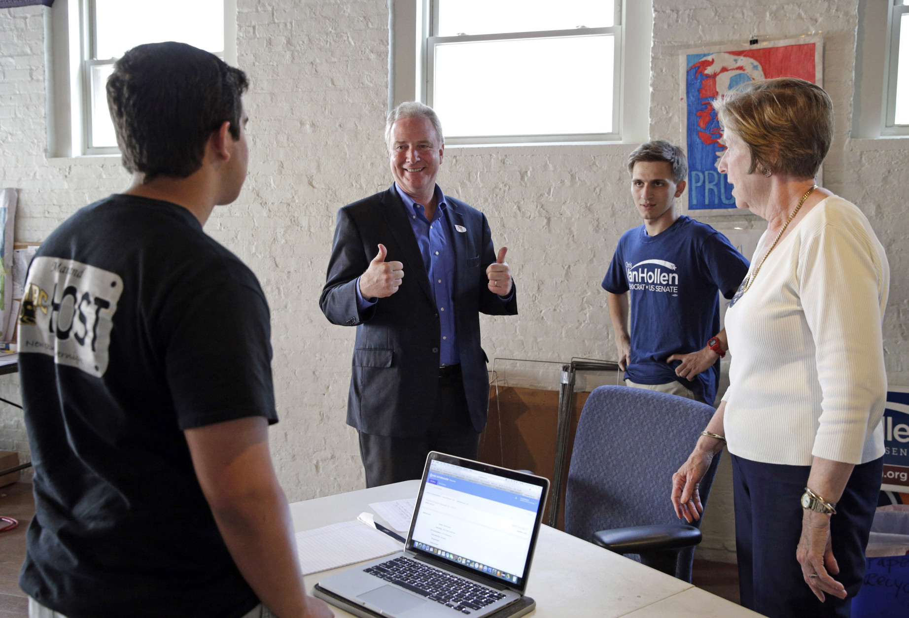 Democratic U.S. Senate candidate, Rep. Chris Van Hollen, D-Md., second from left, greets volunteers inside his field office in Baltimore, Tuesday, April 26, 2016. Van Hollen is running against Rep. Donna Edwards, D-Md., in the Democratic primary for U.S. Senate. (AP Photo/Patrick Semansky)