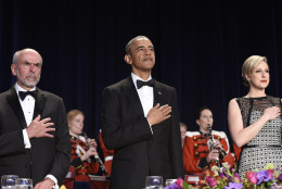 President Barack Obama, center, listens to the National Anthem flanked by Jerry Seib, left, and Carol Lee, of The Wall Street Journal, at the annual White House Correspondents' Association dinner at the Washington Hilton in Washington, Saturday, April 30, 2016. (AP Photo/Susan Walsh)