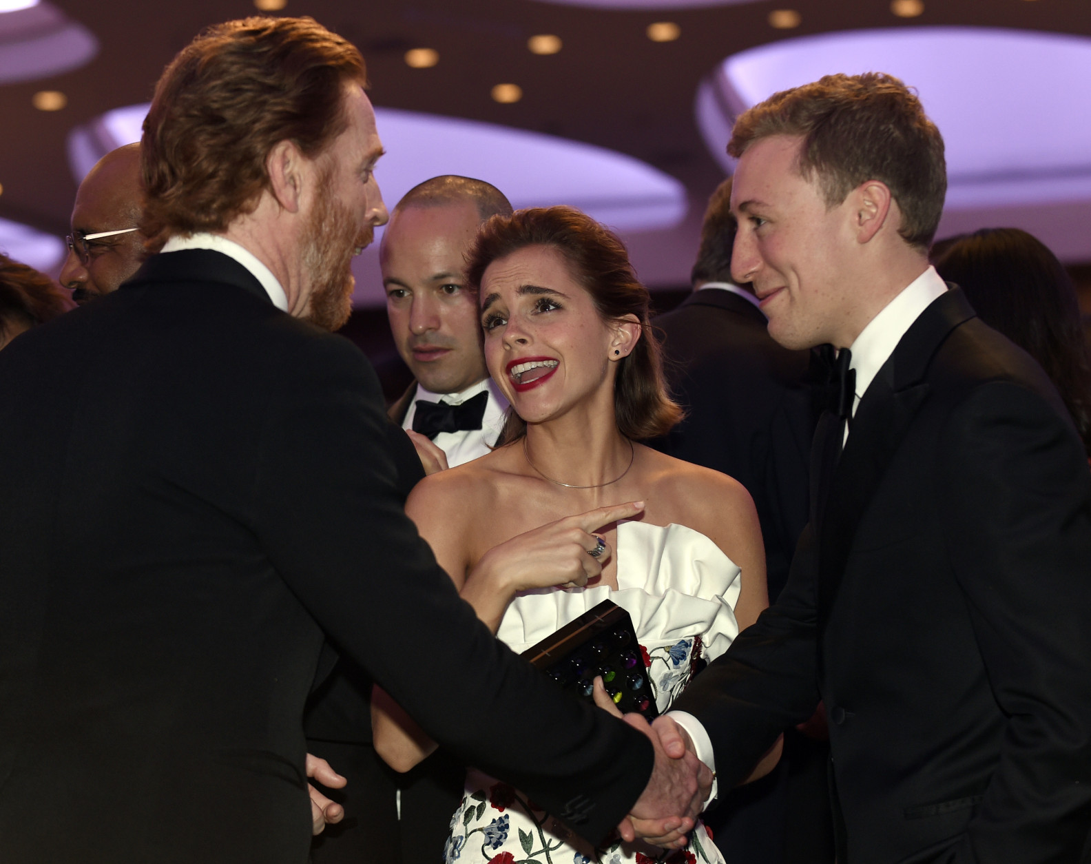 Actress Emma Watson, center, talks with Homeland actor Damian Lewis, left, at the annual White House Correspondents' Association dinner at the Washington Hilton, in Washington, Saturday, April 30, 2016. (AP Photo/Susan Walsh)