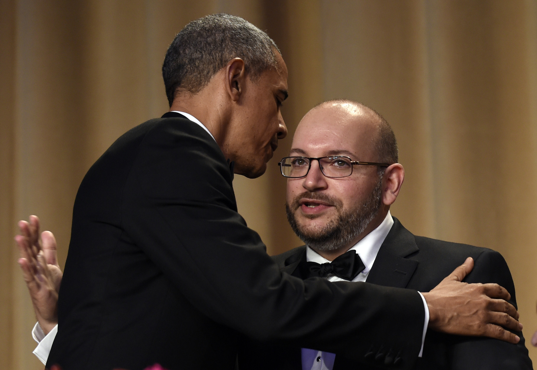 President Barack Obama, left, hugs Jason Rezaian, right, the Washington Post reporter freed after being detained for more than 18 months in Iran, during the annual White House Correspondents' Association dinner at the Washington Hilton in Washington, Saturday, April 30, 2016. (AP Photo/Susan Walsh)