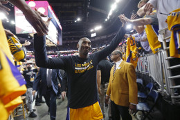 Los Angeles Lakers forward Kobe Bryant greets fans as he leaves the court after an NBA basketball game against the New Orleans Pelicans in New Orleans, Friday, April 8, 2016. The Pelicans won 110-102. Bryant says he will be retiring at the end of the season, thus his last NBA game in New Orleans. (AP Photo/Gerald Herbert)