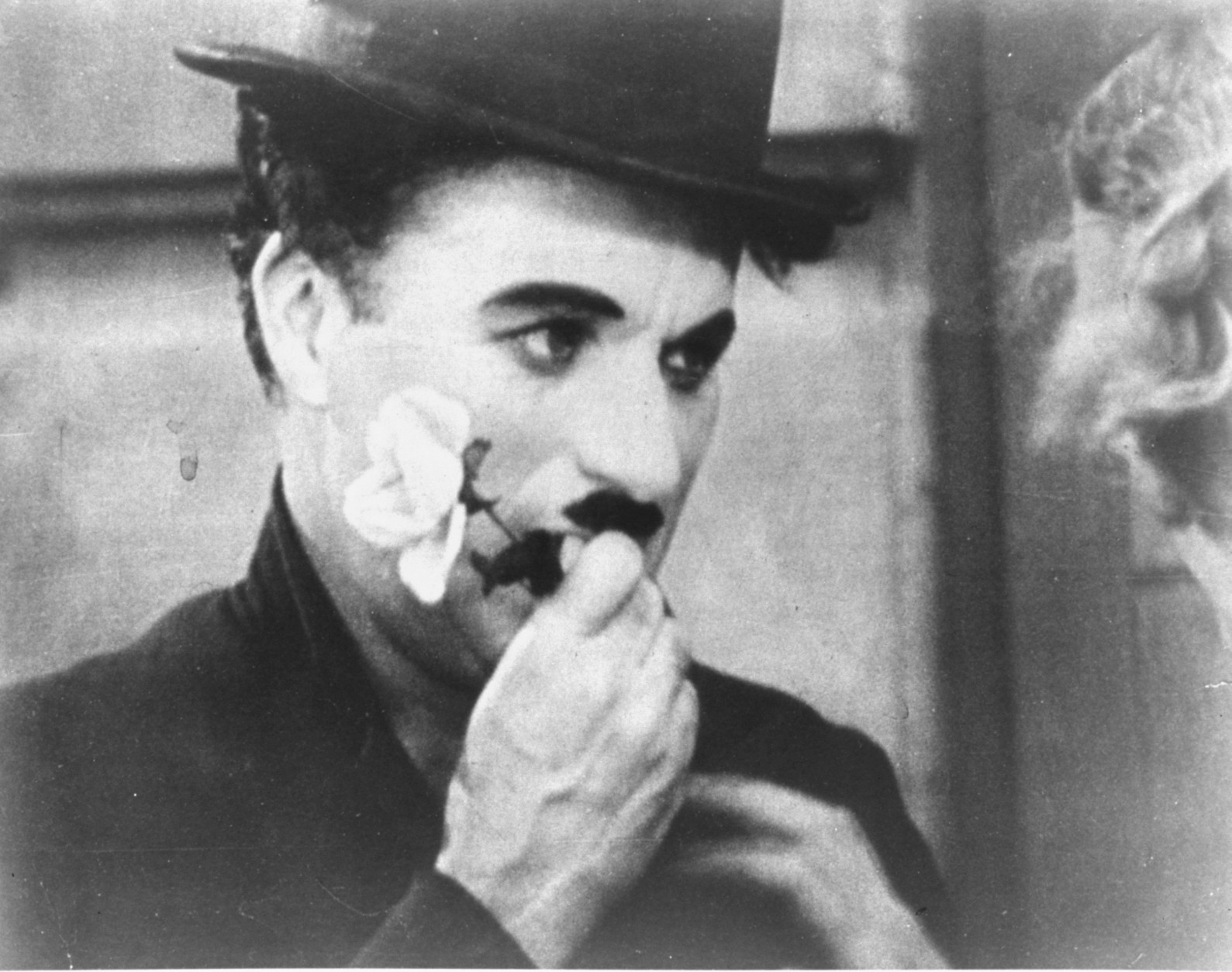 ** FILE ** Charlie Chaplin holds a rose in this photo from the final scene in his 1931 silent film "City Lights".   The film is among the American Film Institute's best romantic comedy movies. (AP Photo)