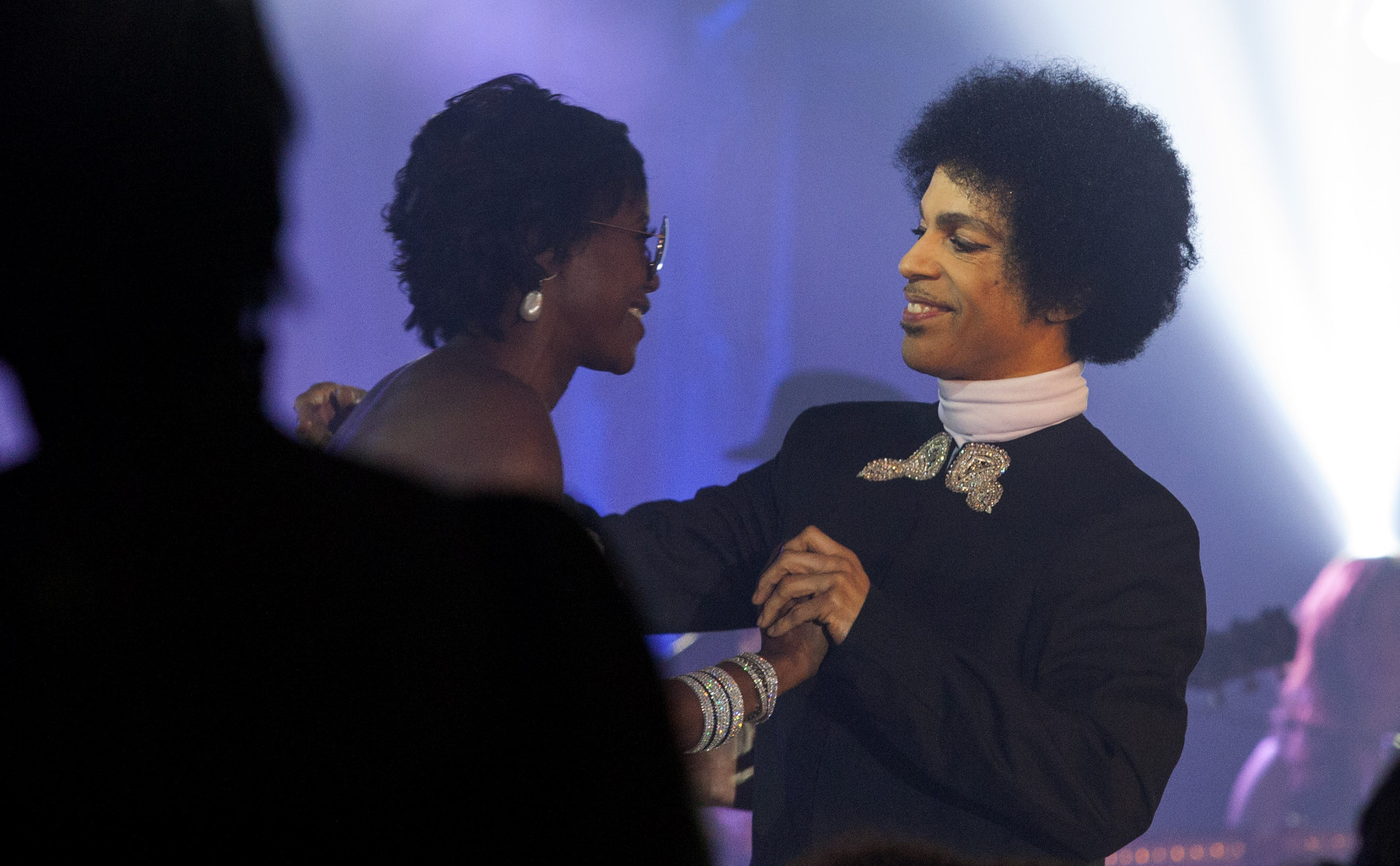 Mellody Hobson is pulled on stage with Prince during the George Lucas and Mellody Hobson's wedding reception at Promontory Point on Saturday, June 29, 2013 in Chicago. (Photo by Barry Brecheisen/Invision/AP)