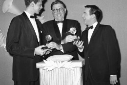 Master of ceremonies Meredith Wilson, center, presents Grammy Awards at night on Nov. 30, 1959 in Hollywood to pianist Van Cliburn left, and vocalist Bobby Darin, right.   Darin was named the best new artist of the year and his version of  "Mack the Knife" was selected as the best record of 1959.   Van Cliburn was honored for his presentation of Rachmaninoff's Piano Concerto No. 3. (AP Photo/Ed Widdis)