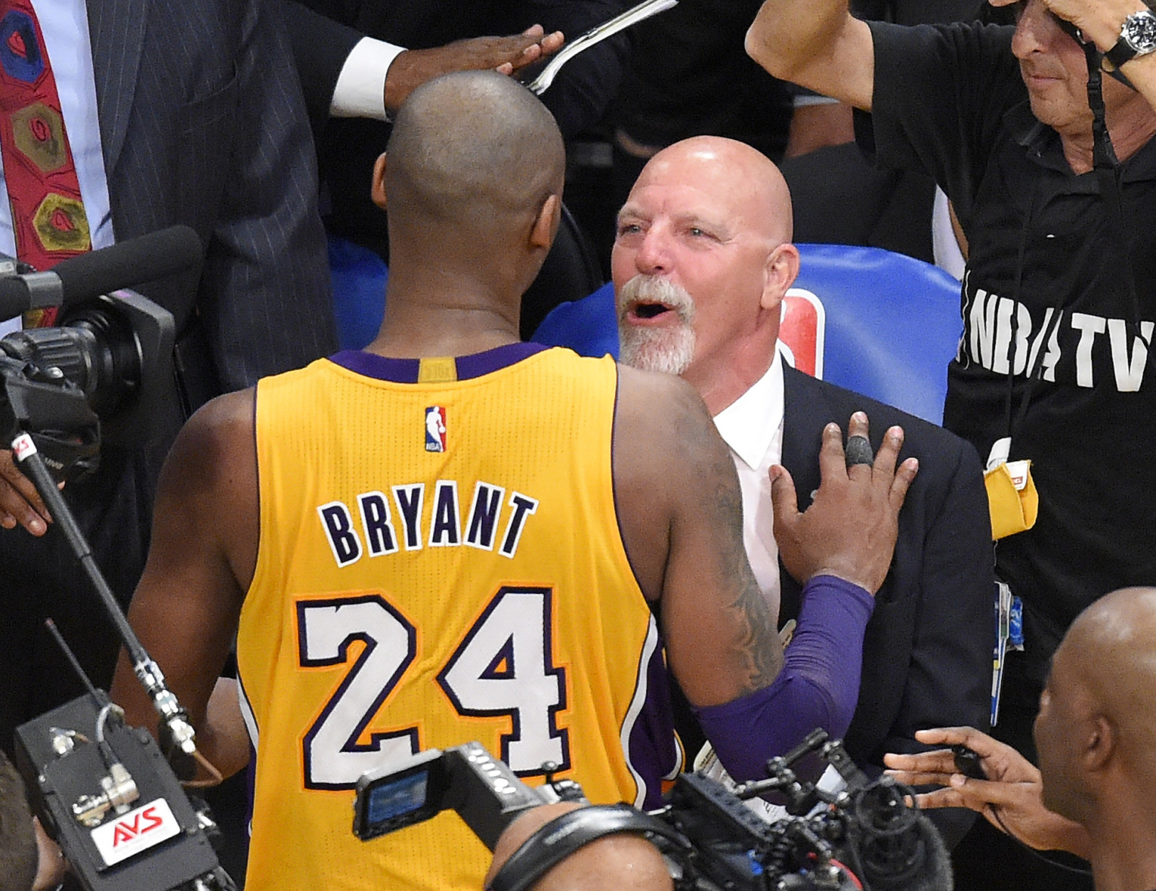 Los Angeles Lakers forward Kobe Bryant, left, and trainer Gary Vitti congratulate each other after an NBA basketball game against the Utah Jazz, Wednesday, April 13, 2016, in Los Angeles. (AP Photo/Mark J. Terrill)