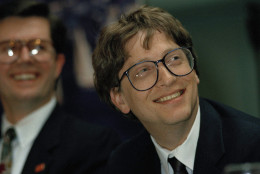 Bill Gates, right, chairman and founder of Microsoft Corp., watches a video presentation prior to giving the keynote address at the annual meeting of the Washington Software Association in Seattle, Wash., Jan. 28, 1992. Looking on is Paul Grey, president of Softchec, Inc. of Kirkland, Wash. (AP Photo/Jim Davidson)