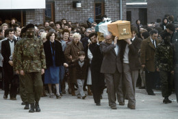 Escorted by hooded members of the IRA, the coffin of hunger striker Bobby Sands leaves a Belfast church followed by his sister Marcella and his 7-year-old son Gerald on May 7, 1981. The cortege was enroute to a burial in Milltown Cemetery. Sands had died on the 66th day of a hunger strike in Belfasts Maze Prison, on May 2nd. (AP Photo/Robert Dear)