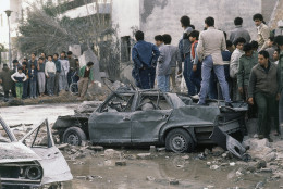 The scene in Tripoli, Libya on April 15, 1986, after an American attack on Libya in the previous at night. It was carried out by the U.S. Air Force and Navy from aircraft carriers and by F-111 jets from bases in Great Britain. In the chaos and confusion on Tuesday in morning people were searching through ruins, streets were littered with burned out cars and from burst water pipes. Among the targets outside Tripoli were Colonel Moammar Gadhafi's headquarters at Al-Aziz, where he has his home and tent. (AP Photo/Merliac/Redman)