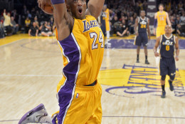 Los Angeles Lakers guard Kobe Bryant goes up for a dunk during the first half of an NBA basketball game against the Utah Jazz, Friday, Jan. 25, 2013, in Los Angeles.  (AP Photo/Mark J. Terrill)