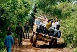 French paratroopers evacuate foreigners loaded on a truck on the outskirts of Kigali, Rwanda, April 13, 1994.  About 1,300 foreigners, including aid workers and missionaries, who were flown out of the capital.  The evacuation was virtually complete, and French and Belgian troops that had been aiding the effort were expected to leave with a few days.  An estimated 20,000 people have been slain in a week of savage massacres and violence.  This is the latest eruption of a decades-long feud between the country's two main ethnic groups.  Hutus dominate the government and comprise 90 percent of Rwanda's 8.5 million people.  The rebels are mainly Tutsis, who make up 9 percent of the population. (AP Photo/Karsten Thielker)