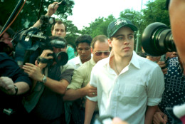 American Michael Fay, 19, accompanied by his father George, behind, leaves the Queenstown Prison in Singapore following his release Tuesday, June 21, 1994.  Fay, who was convicted for spray-painting cars, became the focus of an international uproar when he was flogged for vandalism.  (AP Photo/Tan Ah Soon)