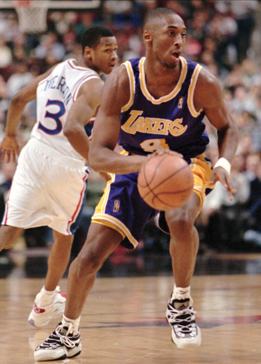Los Angeles Lakers Kobe Bryant, right, moves past Philadelphia 76ers Allen Iverson during the first half of their game, Tuesday, Nov. 26, 1996, in Philadelphia. Bryant graduated from a suburban Philadelphia high school last year. (AP Photo/Rusty Kennedy)