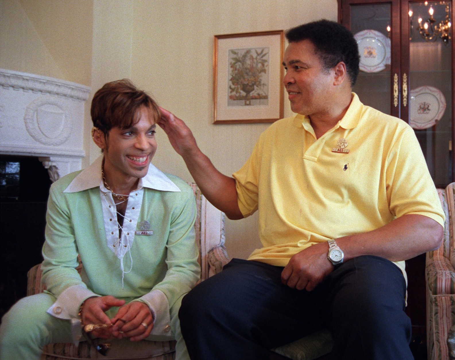 Boxing great Muhammad Ali, right, pats the head of the Artist Formerly Known as Prince during a meeting in Washington Tuesday, June 24, 1997 prior to a news conference where they were to announce plans for a benefit concert in October. The World Healing Honors will be a grand benefit concert to promote international harmony and tolerance. (AP Photo/Karin Cooper/Rogers &amp; Cowan)
