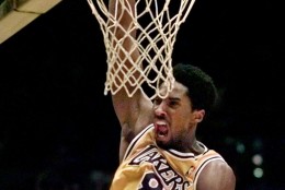 Los Angeles Lakers' Kobe Bryant slam dunks in the closing seconds  against the Phoenix Suns Wednesday, March 3, 1999, in Inglewood, Calif. The Lakers won 101-95. (AP Photo/Mark J. Terrill)