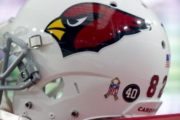 An NFL Salute to Service logo and a Pat Tillman "40" is shown on th back of a Arizona Cardinals players' helmet during the second half of an NFL football game against the St. Louis Rams, Sunday, Nov. 9, 2014, in Glendale, Ariz. (AP Photo/Rick Scuteri)