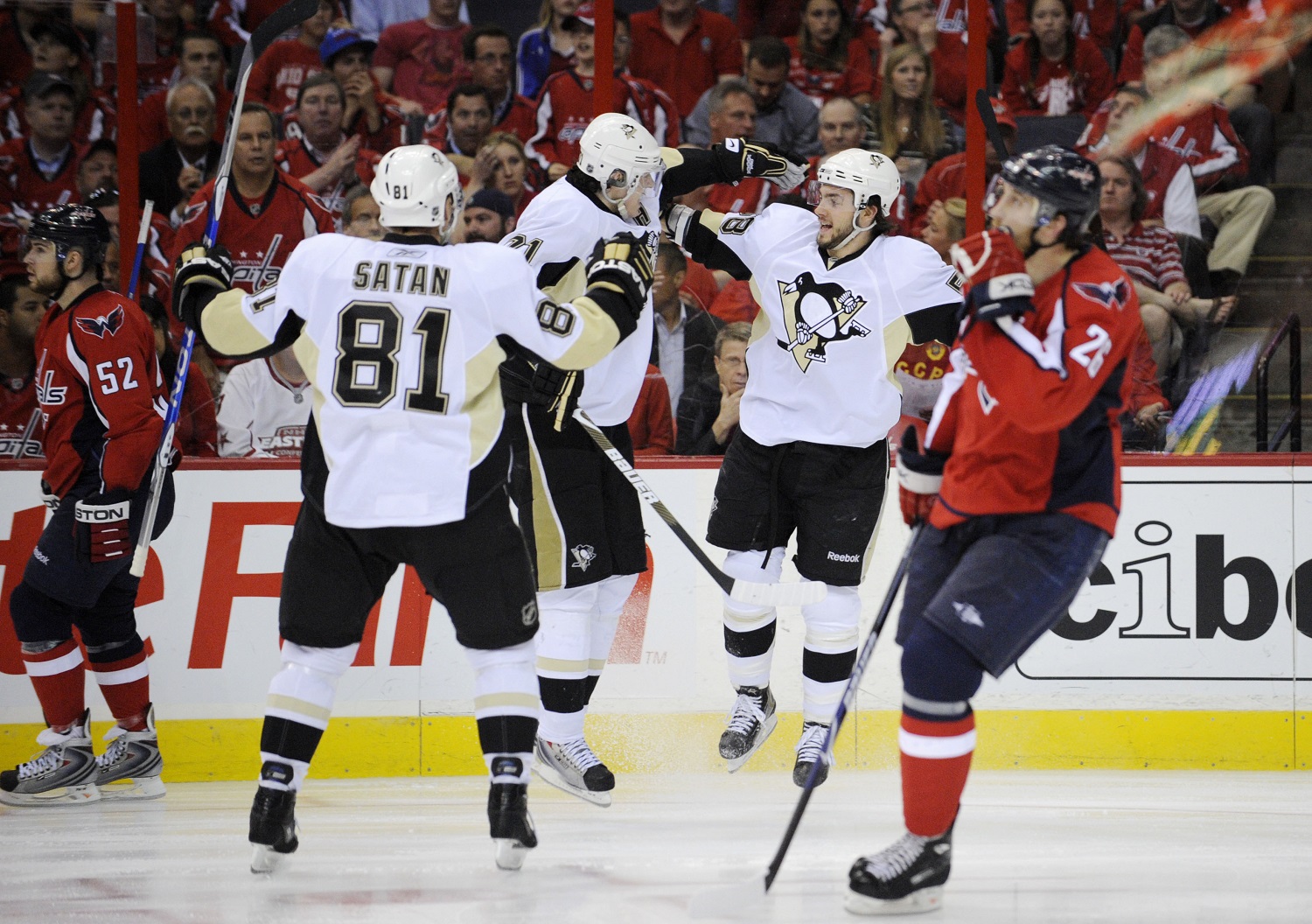 Pittsburgh Penguins' Kris Letang, second from right, celebrates his goal with Evgeni Malkin (71), from Russia, and Miroslav Satan (81), from Slovakia, as Washington Capitals defensemen Mike Green, left, and Shaone Morrisonn (26) skate past during the second period of Game 7 of an NHL hockey second-round playoff series, Wednesday, May 13, 2009, in Washington. The Penguins won 6-2.(AP Photo/Nick Wass)