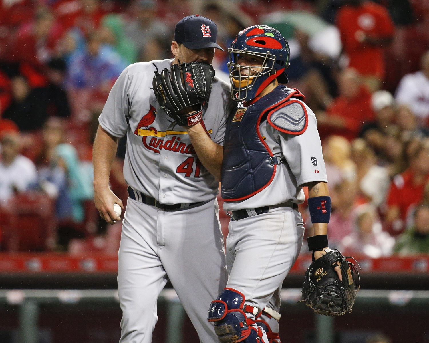 St. Louis Cardinals starting pitcher John Lackey (41) and catcher Yadier Molina (4) meet on the infield during the seventh inning of a baseball game, Friday, Sept. 11, 2015, in Cincinnati. (AP Photo/John Minchillo)