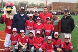 Despite the rain, Little League players pose for a photo with Washington Nationals Ryan Zimmerman. Zimmerman helped fund a multi-use facility in Southwest D.C. The official opening ceremony was held Saturday, April 9, 2016.  (WTOP/John Domen via Twitter)