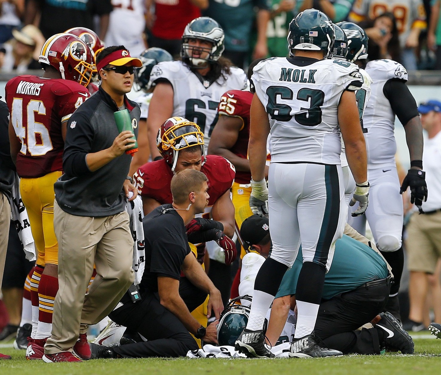 PHILADELPHIA, PA - SEPTEMBER 21: Nick Foles #9 of the Philadelphia Eagles is looked after by medical personal after being hit by Chris Baker #92 of the Washington Redskins during the fourth quarter of a football game at Lincoln Financial Field on September 21, 2014 in Philadelphia, Pennsylvania. Foles returned to the game but Baker was ejected. (Photo by Rich Schultz /Getty Images)
