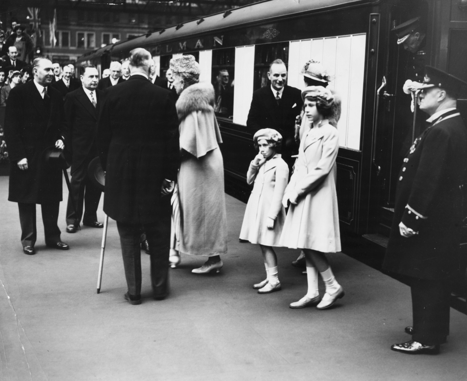 British princesses Elizabeth (right) and Margaret standing together on the train platform as they see off their parents, King George VI and Queen consort Elizabeth, at Waterloo Station, London, May 6th 1939. (Photo by Fox Photos/Hulton Archive/Getty Images)