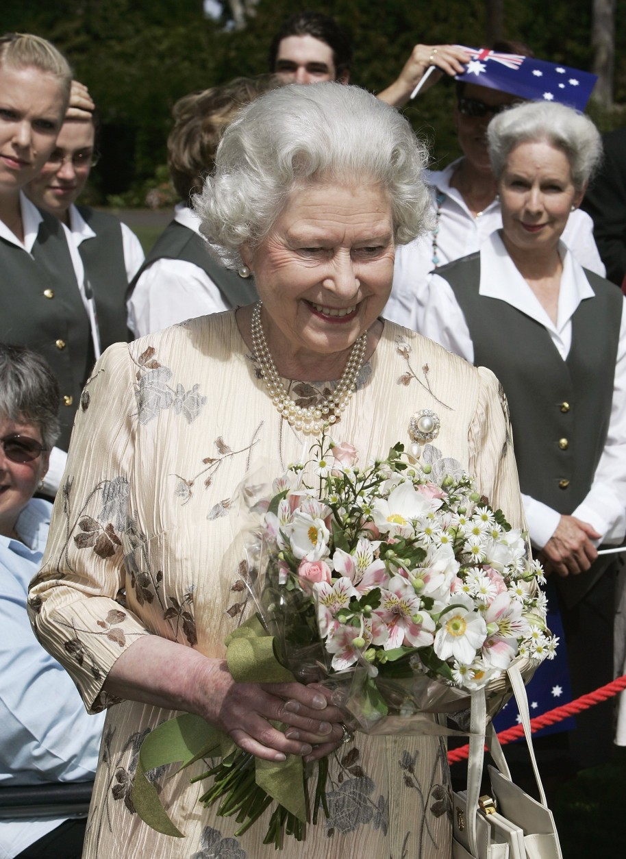 CANBERRA, AUSTRALIA - MARCH 14: Queen Elizabeth II reacts after meeting the families of the staff of Government House after a tree planting ceremony March 14, 2006  in Canberra, Australia. The Queen and Prince Philip are on a five-day visit to Australia where she will officially open the Commonwealth Games in Melbourne.      (Photo by Will Burgess-Pool/Getty Images)