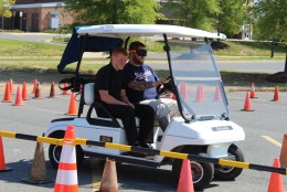 Courtland High School students get a sober glimpse of the dangers of driving impaired by wearing fatal vision goggles and trying to drive a golf cart. (Courtesy of school resource officer Nathaniel L. Allison)