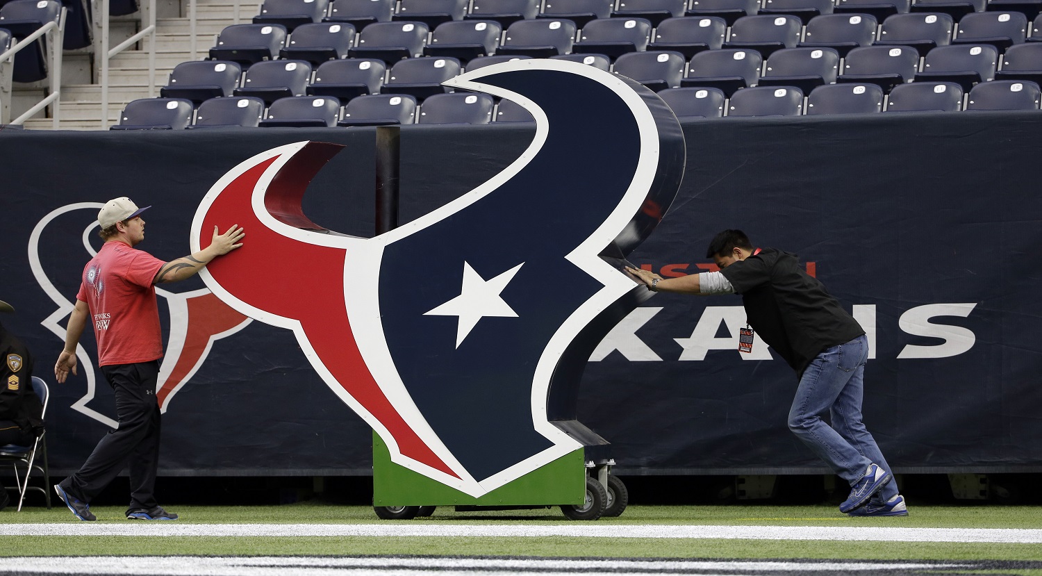 Houston Texans logos are moves at NRG Stadium prior to an NFL football game between the Houston Texans and New York Jets, Sunday, Nov. 22, 2015, in Houston. (AP Photo/David J. Phillip)