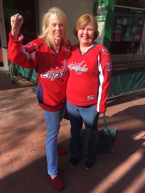 Caps fans Becky Brown and Jody Schotler, from Manassas, show how they're rockin' the red ahead of Game 1 on April 14, 2016. (WTOP/Alan Etter)