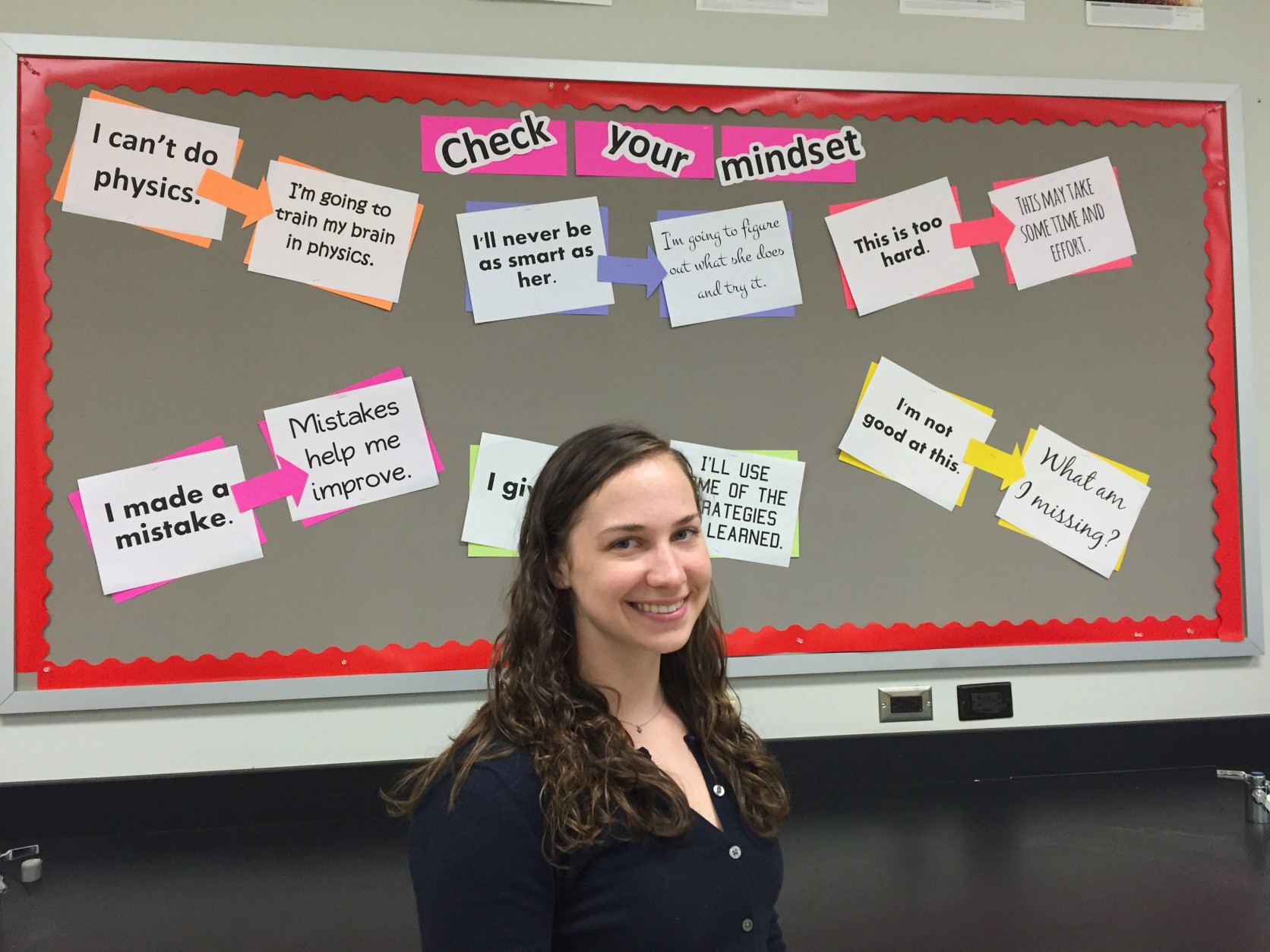 Miller in front of a bulletin board in her classroom. She'll be doing cutting-edge field research at the South Pole, and will share her experiences and findings with students. (WTOP/Michelle Basch)