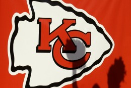 A Kansas City Chiefs cheerleader casts a shadow on a logo during the second half of an NFL football game against the New York Jets, Sunday, Nov. 2, 2014, in Kansas City, Mo. The Chiefs won 24-10. (AP Photo/Charlie Riedel)