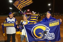Football fans cheer for the return of the Rams to Los Angeles on the site of the old Hollywood Park horse-racing track in Inglewood, Calif., on Tuesday, Jan. 12, 2016. NFL owners voted Tuesday night to allow the St. Louis Rams to move to a new stadium at the site just outside Los Angeles, and the San Diego Chargers will have an option to share the facility. (AP Photo/Damian Dovarganes)