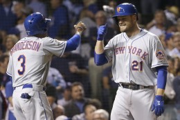New York Mets' Lucas Duda is congratulated by Curtis Granderson after hitting a three-run home run during the first inning of Game 4 of the National League baseball championship series against the Chicago Cubs Wednesday, Oct. 21, 2015, in Chicago. (AP Photo/David J. Phillip)