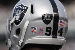 A logo for recently passed Oakland Raiders owner Al Davis is shown on the helmet of defensive end Jarvis Moss (94)  in the fourth quarter of an NFL football game against the Cleveland Browns in Oakland, Calif., Sunday, Oct. 16, 2011. (AP Photo/Paul Sakuma)