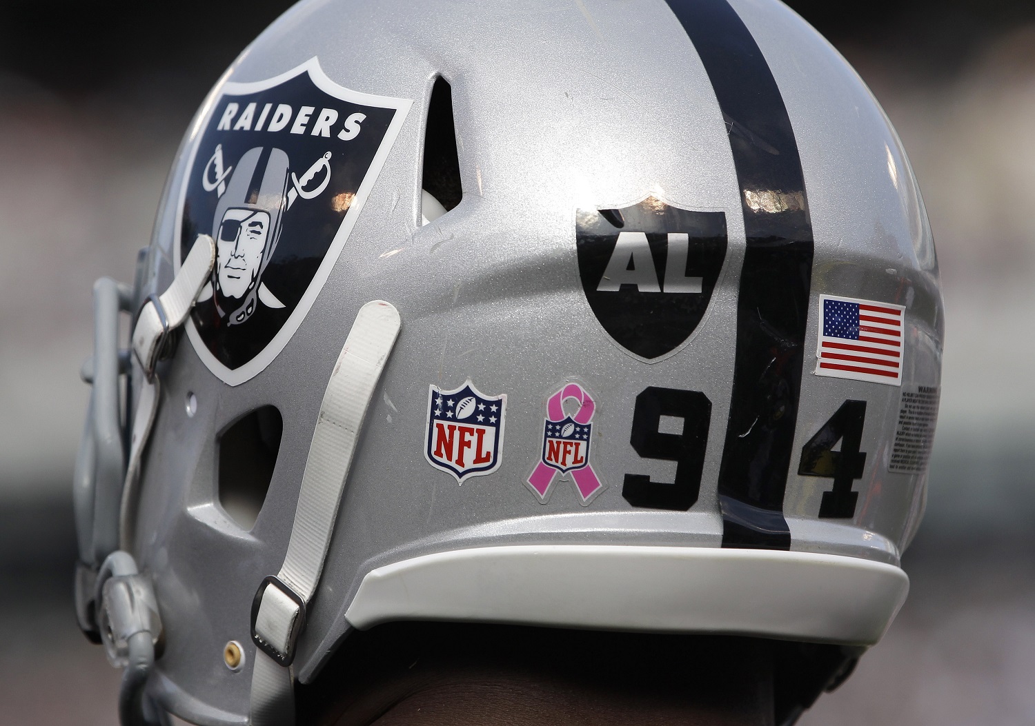 A logo for recently passed Oakland Raiders owner Al Davis is shown on the helmet of defensive end Jarvis Moss (94)  in the fourth quarter of an NFL football game against the Cleveland Browns in Oakland, Calif., Sunday, Oct. 16, 2011. (AP Photo/Paul Sakuma)