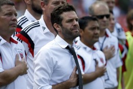 D.C. United head coach Ben Olsen, center in tie, stands during the National Anthem, before an MLS soccer match against the New York Red Bulls, at RFK Stadium, Sunday, Aug. 31, 2014, in Washington. (AP Photo/Alex Brandon)