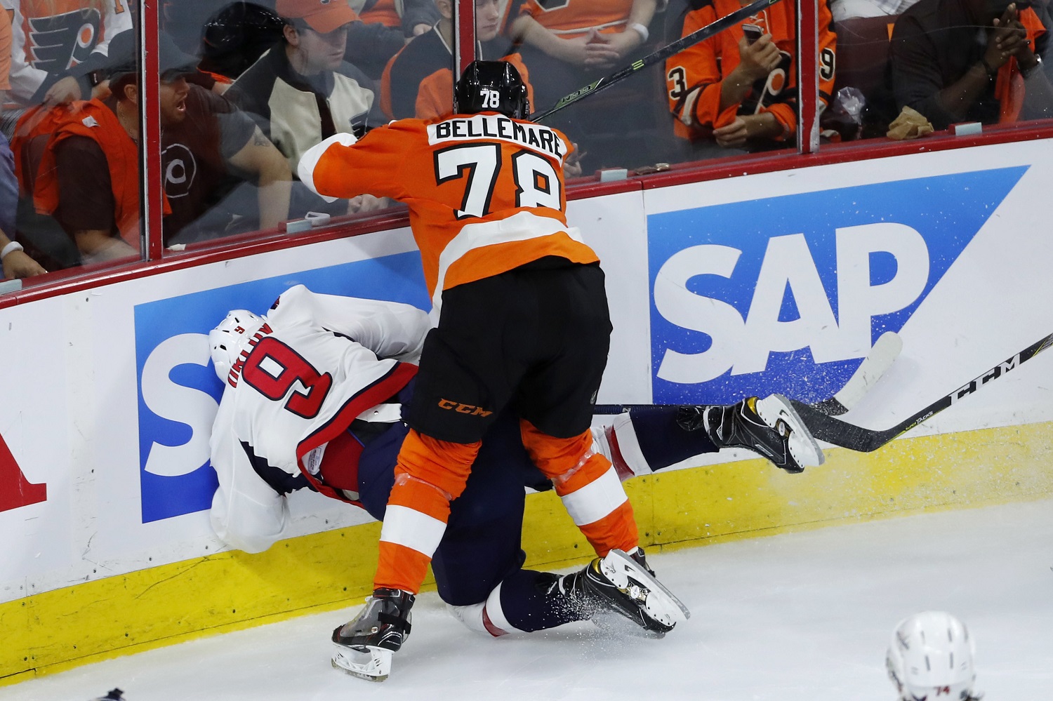 Philadelphia Flyers' Pierre-Edouard Bellemare (78) collides with Washington Capitals' Dmitry Orlov (9) during the third period of Game 3 in the first round of the NHL Stanley Cup hockey playoffs, Monday, April 18, 2016, in Philadelphia. Washington won 6-1. (AP Photo/Matt Slocum)