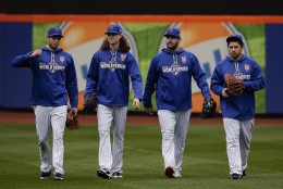 From left, New York Mets pitchers Steven Matz, Jacob deGrom and Matt Harvey and catcher Travis d'Arnaud walk off the field at the end of batting practice, Saturday, Oct. 24, 2015, in New York.  The Mets will face the Kansas City Royals in Game 1 of the World Series on Tuesday. (AP Photo/Julie Jacobson)